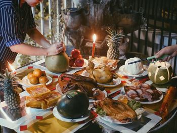 Midsection of friends with food on table