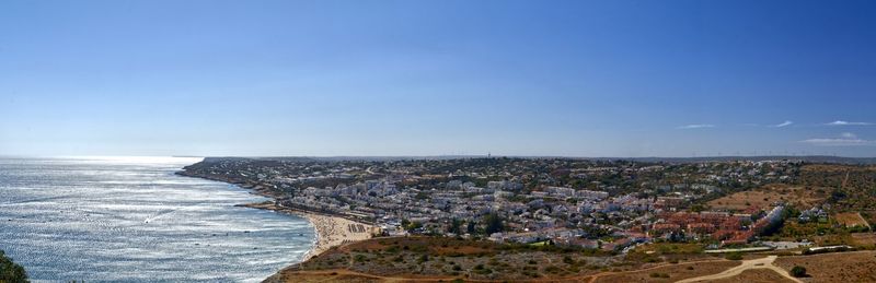 High angle view of sea and buildings against sky