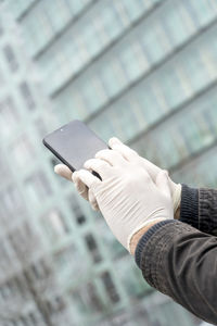 Midsection of person holding mobile phone