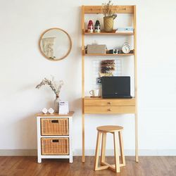 Table and chairs for work in natural wood with rattan and wall decoration