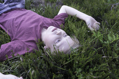 Boy relaxing on field