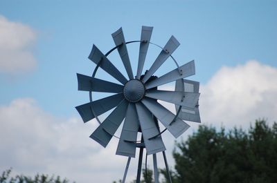 Low angle view of windmill against sky