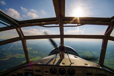 Airplane window against sky