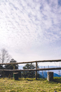 Bridge over field against sky