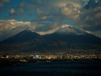 Scenic view of sea and mountains against sky