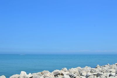 Scenic view of sea against clear blue sky