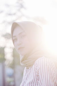 Side view of woman wearing hijab during sunset