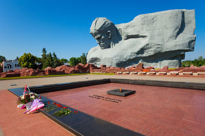 Statue in front of built structure