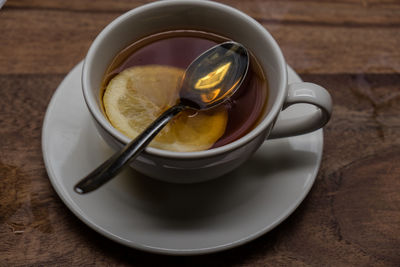 High angle view of herbal tea with lemon slice on table