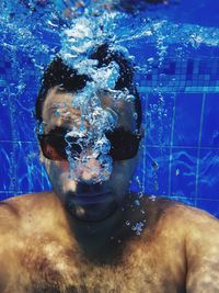 Portrait of young man in swimming pool