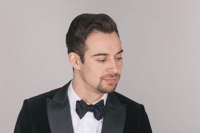 Portrait of young man against white background