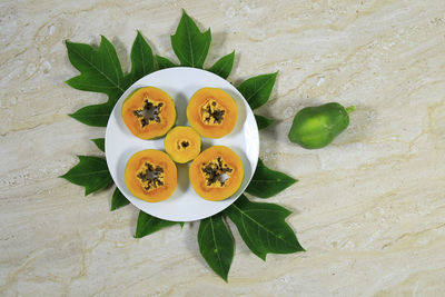 High angle view of fruits and leaves on table