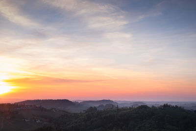Scenic view of landscape against romantic sky at sunset