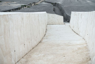 High angle view of footpath by wall