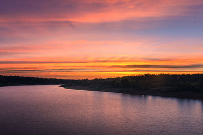 Scenic view of lake against romantic sky at sunset