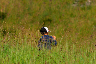 Rear view of a grass in field