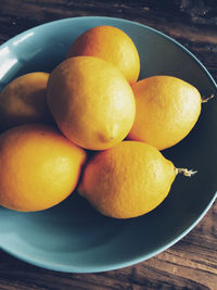 Close-up of lemons in plate on table