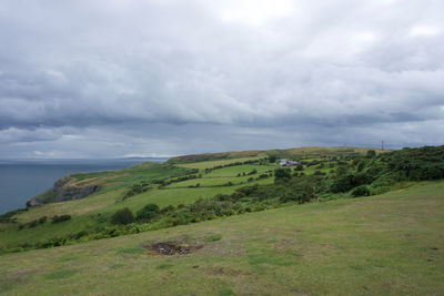 Scenic view of landscape and sea against sky