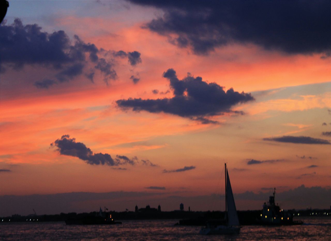 sunset, orange color, sea, sky, water, nautical vessel, transportation, mode of transport, cloud - sky, scenics, silhouette, beauty in nature, waterfront, boat, tranquility, tranquil scene, nature, dramatic sky, idyllic, travel