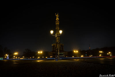 Statue of illuminated city at night