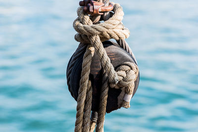 Close-up of rope tied on blue sky