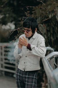 Young man smoking cigarette