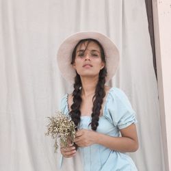 Portrait of beautiful young woman wearing hat