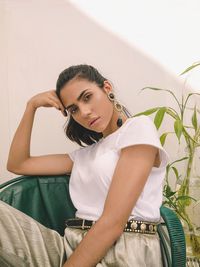 Portrait of fashionable woman sitting at home