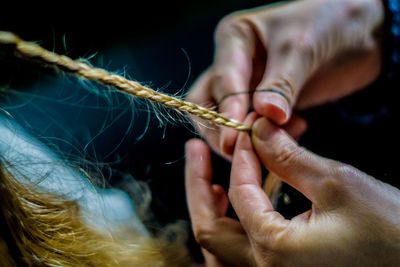 Close-up of woman braiding hair