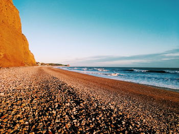 Scenic view of beach against clear sky