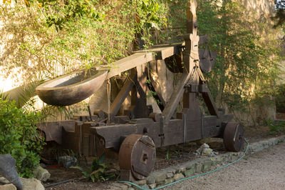 Abandoned truck on field in forest