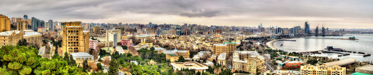 High angle view of buildings against cloudy sky