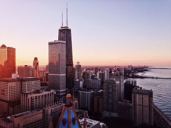 Willis tower by sea against sky in city