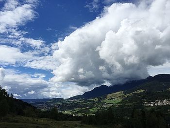 Scenic view of mountains against cloudy sky