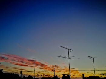 Silhouette of wind turbines against clear sky