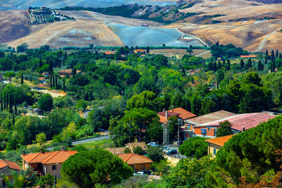 High angle view of houses amidst trees and buildings