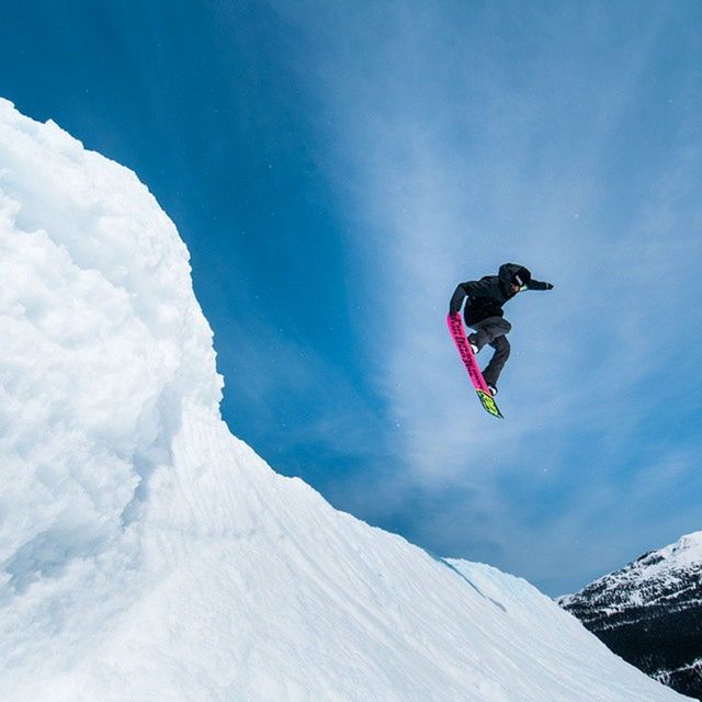 snow, winter, cold temperature, mountain, season, low angle view, mid-air, full length, sky, weather, one person, flying, nature, extreme sports, adventure, blue, snowcapped mountain, bird, beauty in nature, freedom