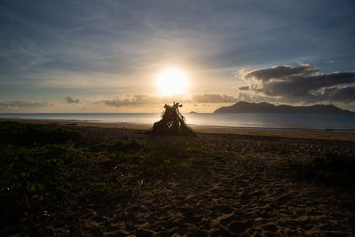 Scenic view of beach against sky during sunset