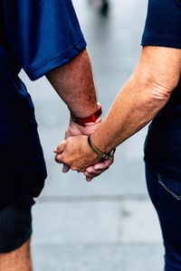 Midsection of man holding hands