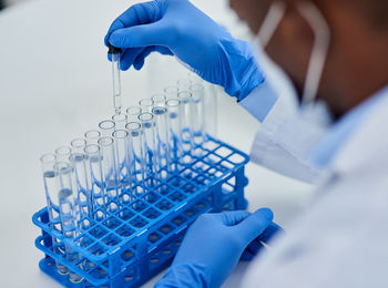 Midsection of scientist examining chemical in laboratory