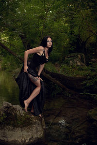 Beautiful woman looking away in forest