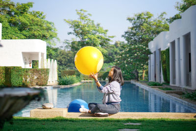 People sitting on balloons