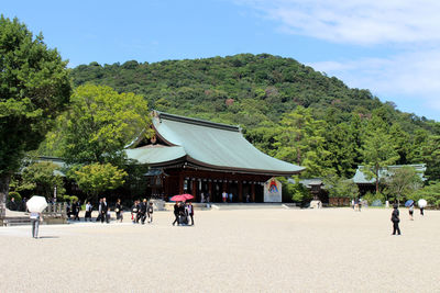 Group of people in front of built structure against sky