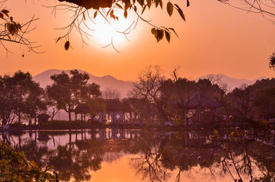Scenic view of lake against orange sky