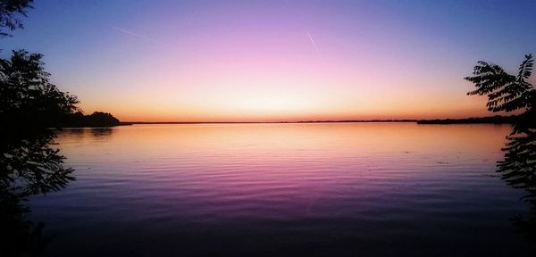 Scenic view of lake against sky during sunset