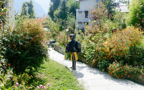 Solo woman in hiking sportswear and with a backpack on her shoulders. 