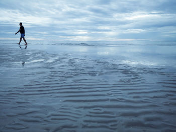 Full length of man on beach against sky