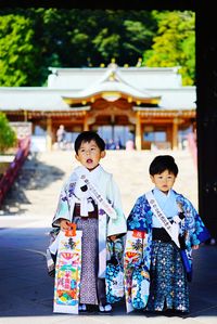 Boys wearing kimonos against temple