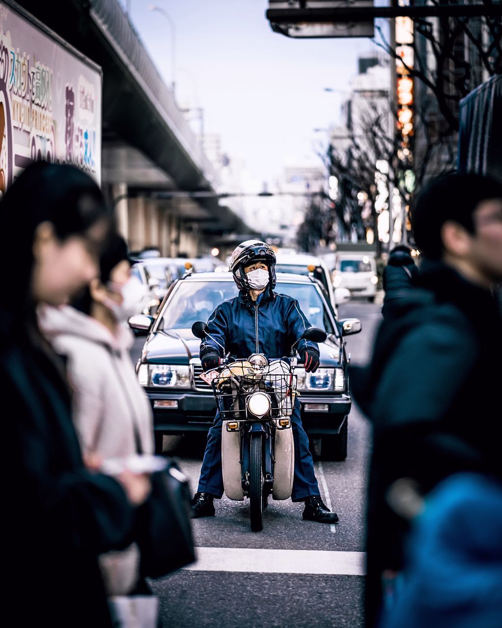 city, transportation, real people, mode of transportation, architecture, street, men, people, land vehicle, group of people, lifestyles, city life, selective focus, day, bicycle, women, travel, building exterior, incidental people, built structure, uniform