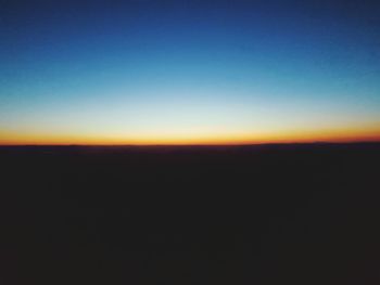 Scenic view of silhouette landscape against clear sky during sunset